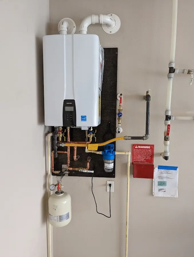 Professional plumber installing copper piping in a Hazle home